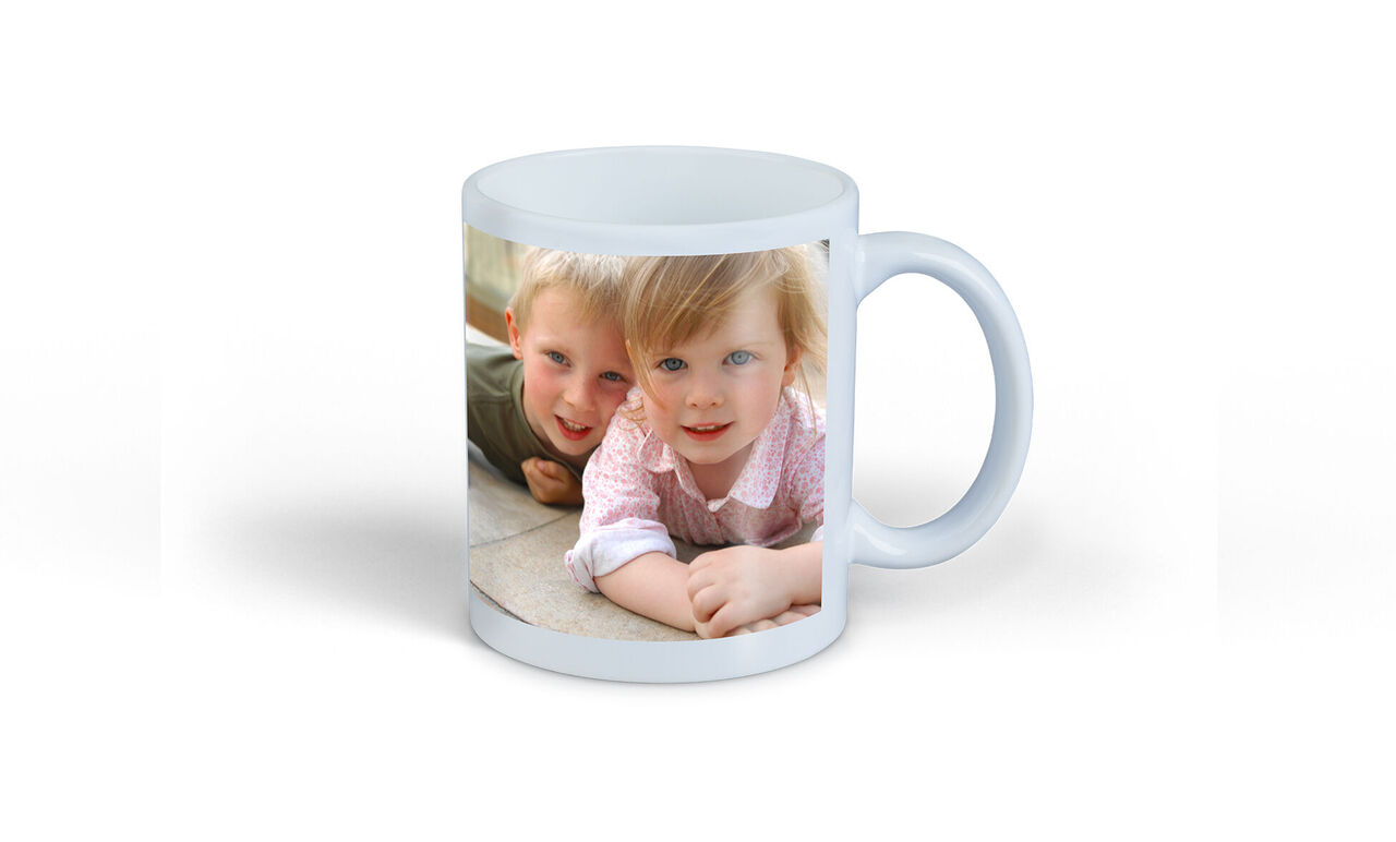 A cup with a loving photo of two small children smiling and playing together