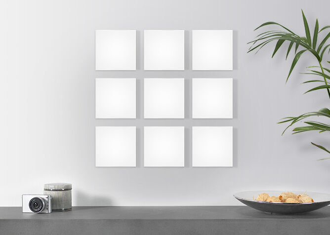 Nine empty photo plates for designing on a wall.
