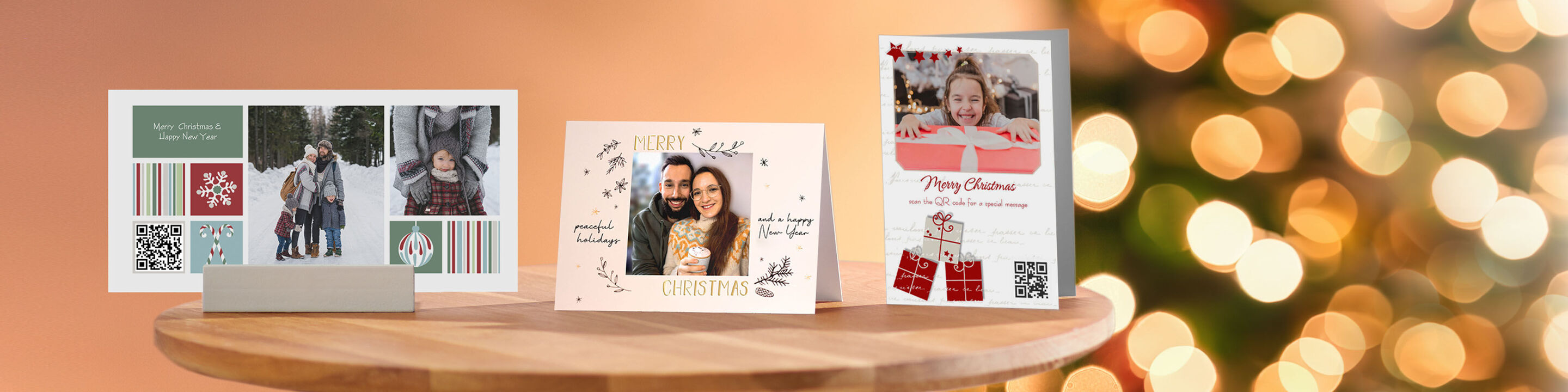Three lovingly designed CEWE greeting cards on a table. Christmas lights shine in the background.