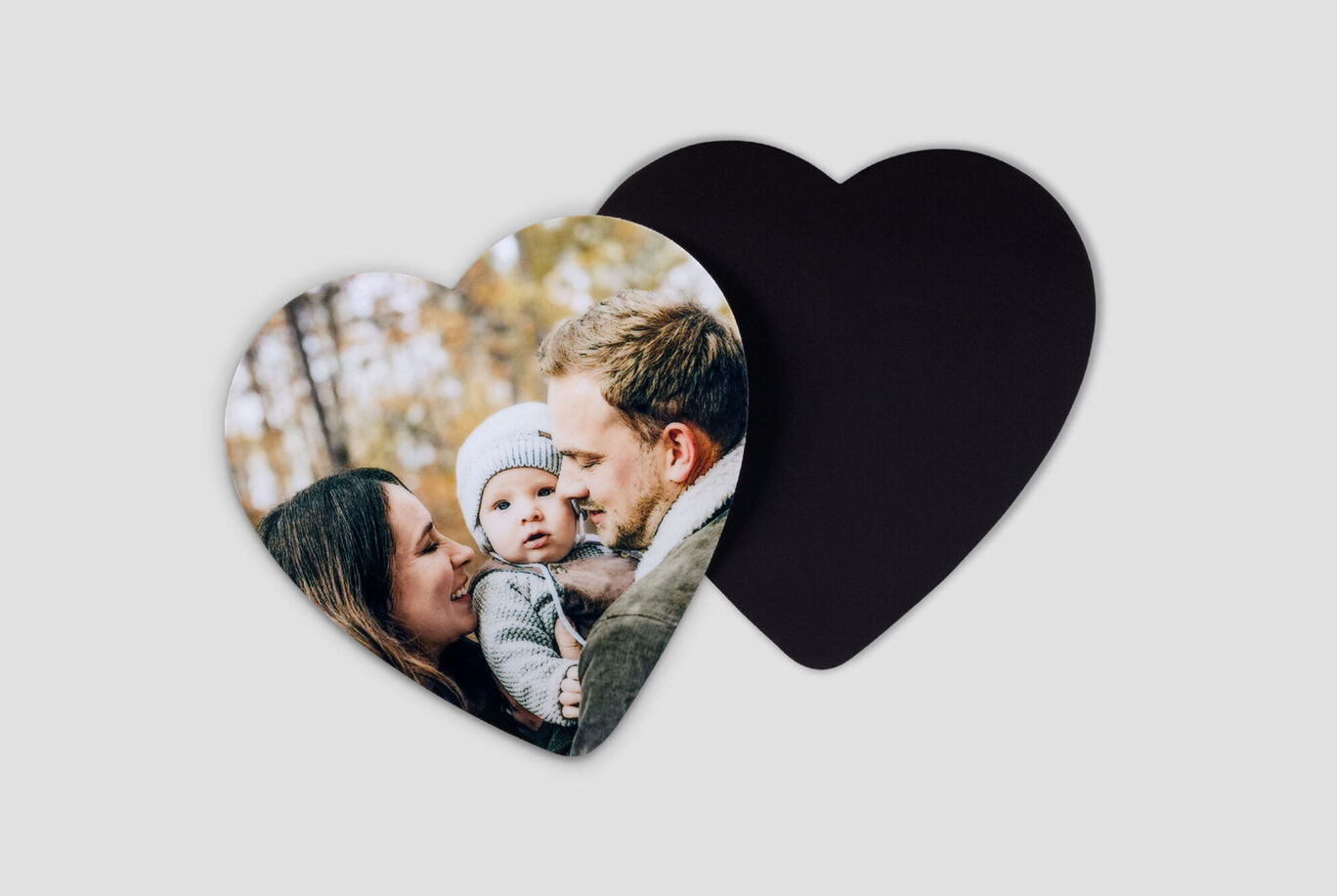 A heart-shaped photo shows a happy family in nature.