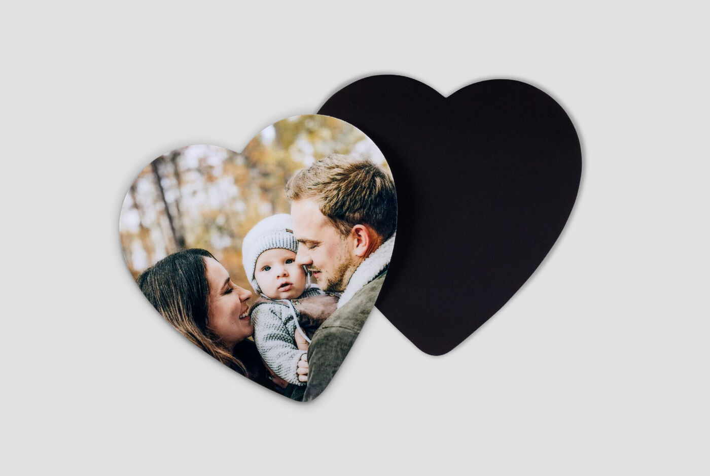 A heart-shaped photo shows a happy family in nature.