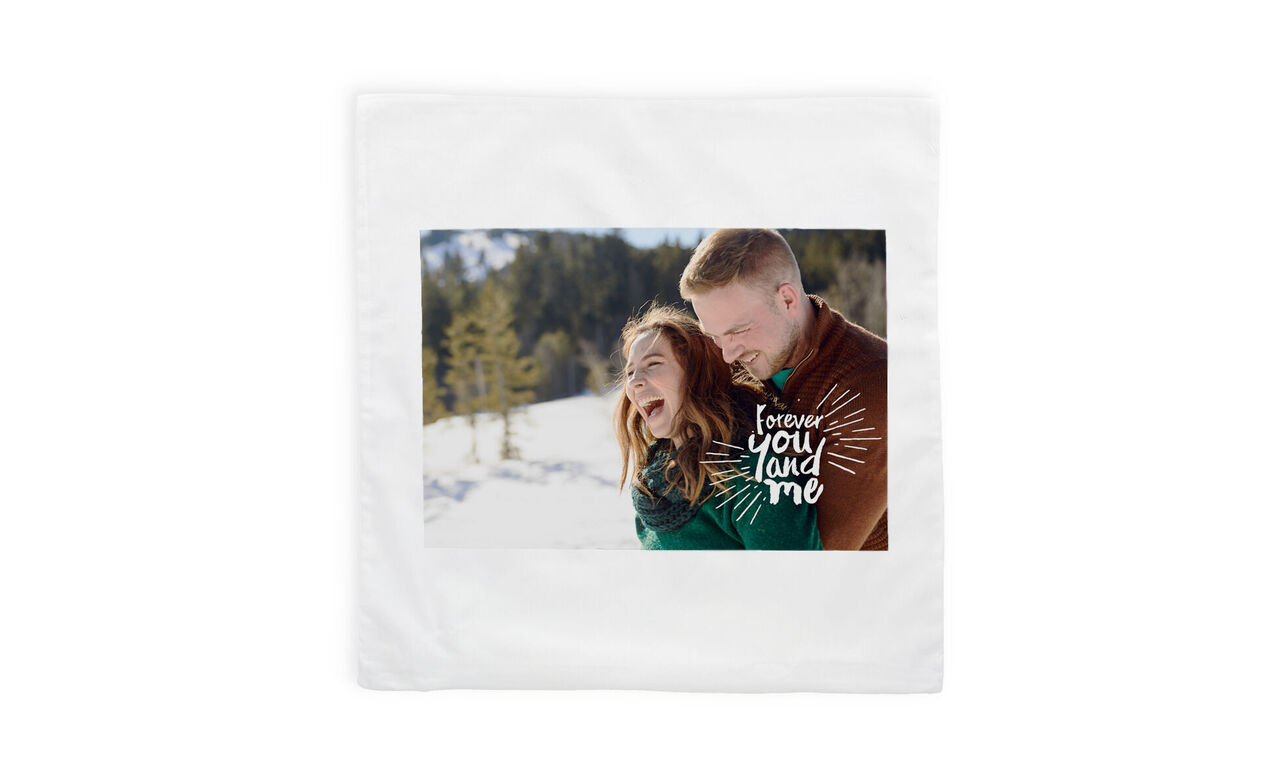 A happy couple embracing in a winter landscape, surrounded by snowy trees. A loving phrase emphasizes affection.
