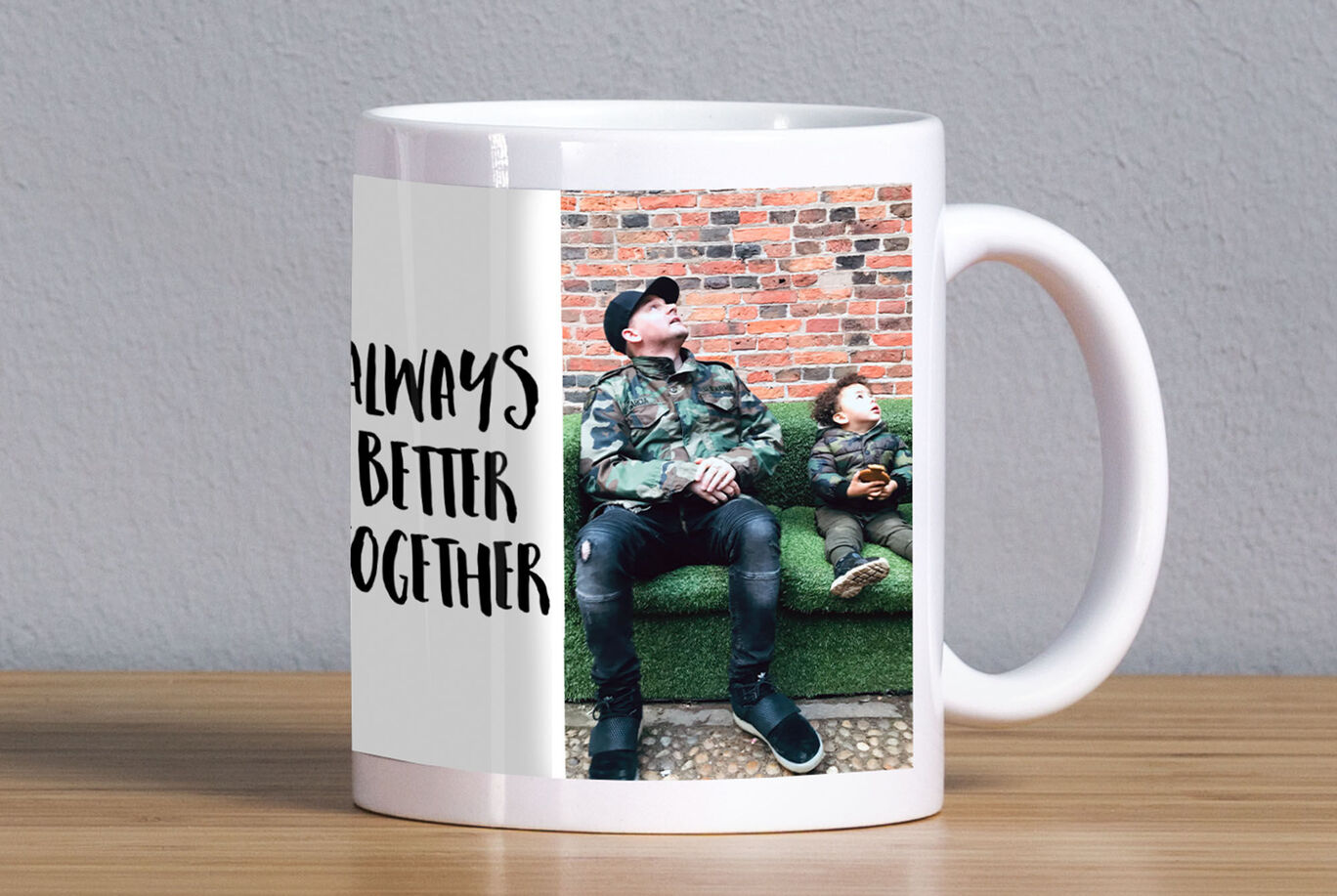 Father and child sitting relaxed on a couch, mug with 'Always Better Together'