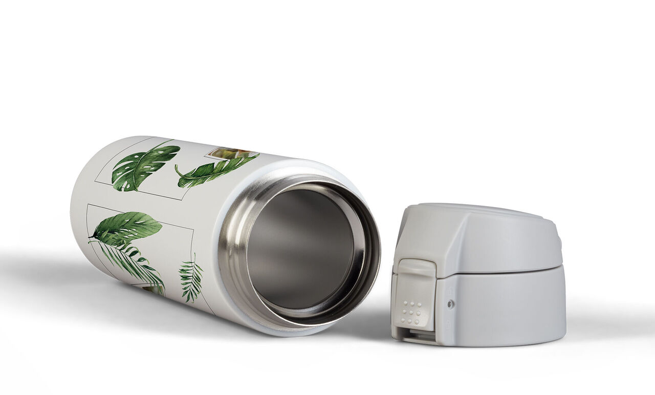 Reusable thermos bottle with green leaf design and a white lid.