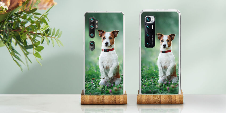 Two phone cases with a white dog on a green background.