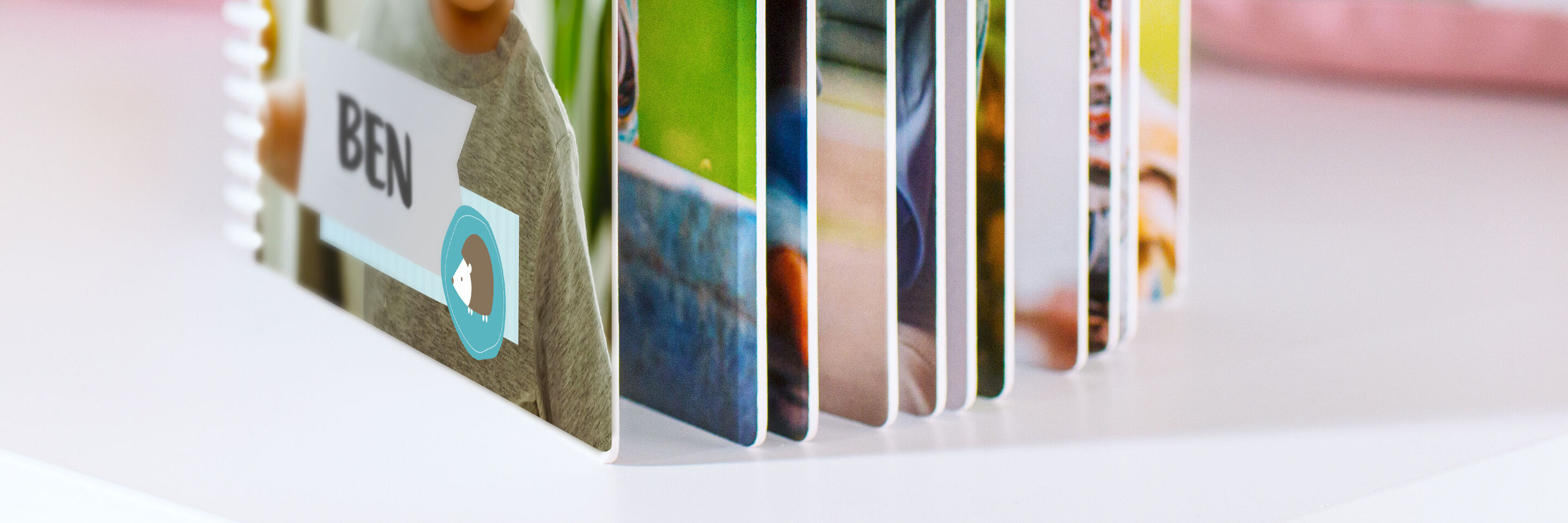 A CEWE PHOTO BOOK with a personalized cover showing the name "Ben".