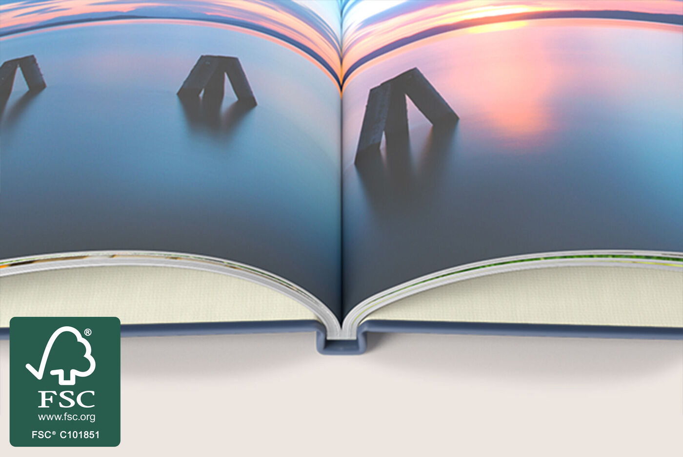 Open CEWE photo book with images of spectacular landscapes.