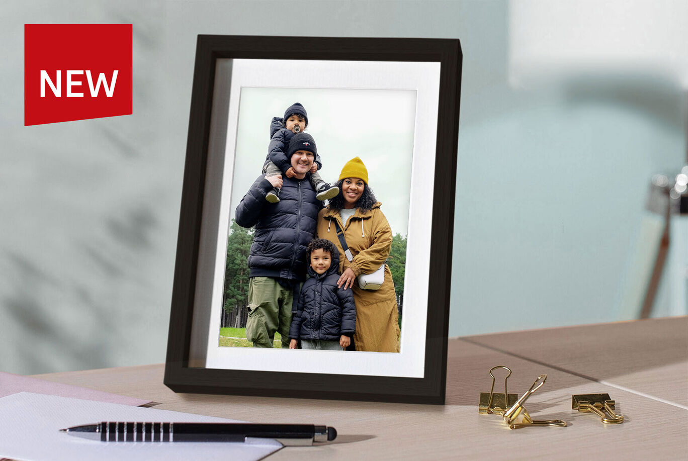 Family photo in a modern frame on a table.