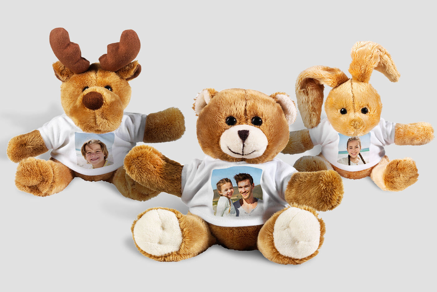 Three plush toys with photos on their shirts radiate joy.