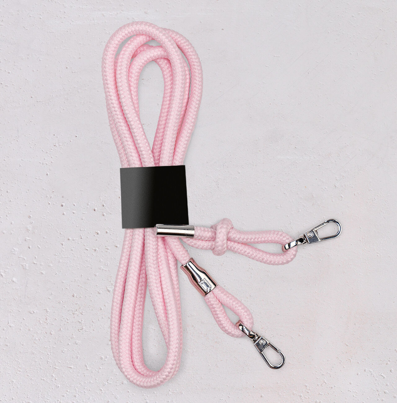 Trekkö rope in pink, featuring silver clasps, neatly arranged on a light background