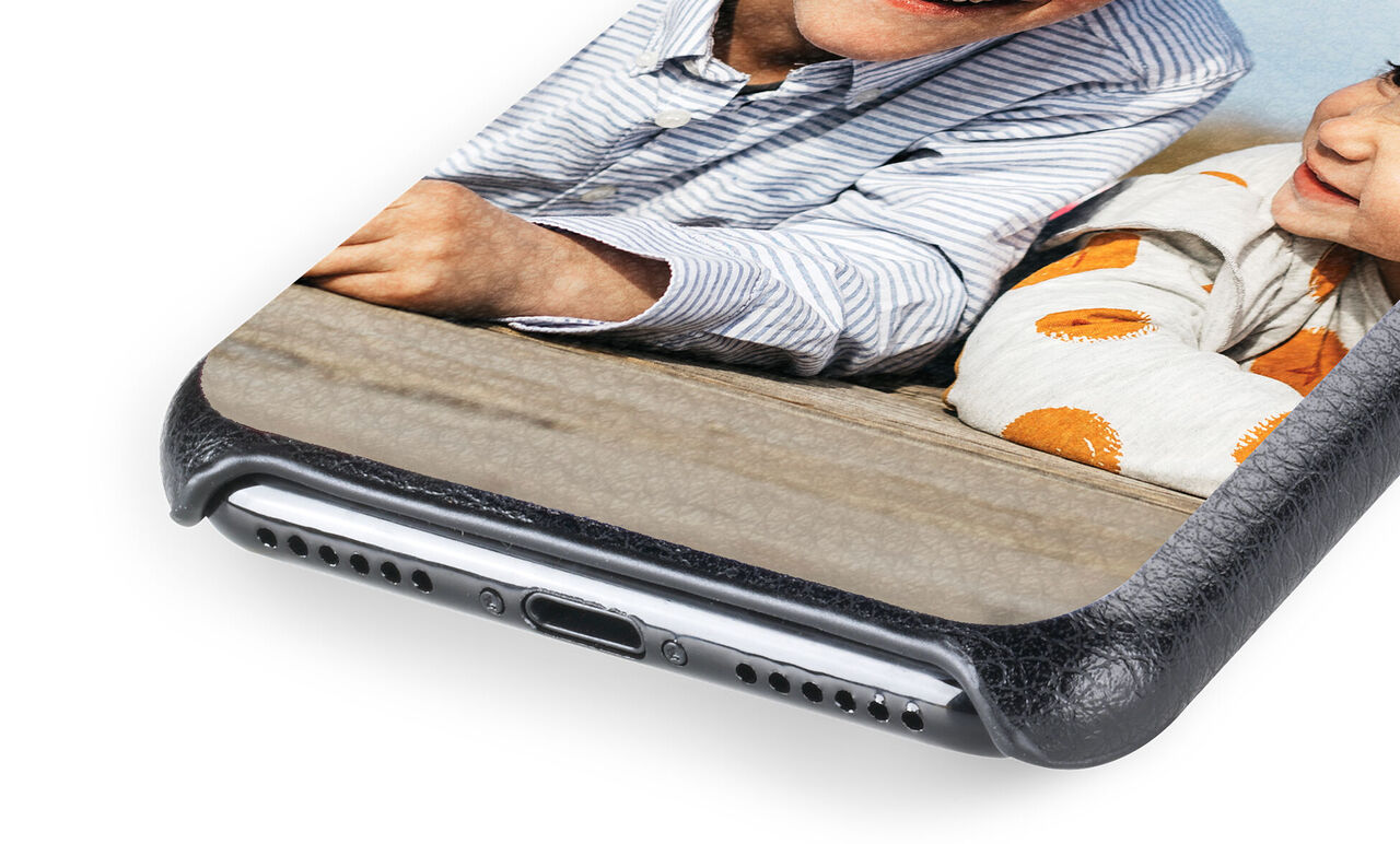 Close-up of a phone case featuring a smiling father and child interacting, showing a loving relationship
