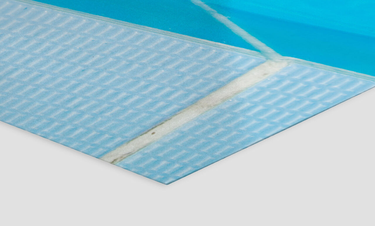 Close-up of a blue swimming pool liner with a textured surface