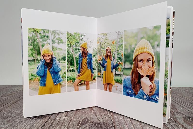 An open photo book with joyful snapshots on a meadow. Each picture shows a person in a yellow dress and blue denim jacket.