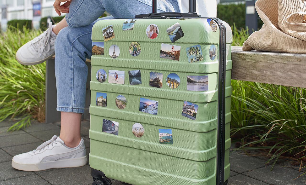 Green travel bag with memory stickers on a bench.