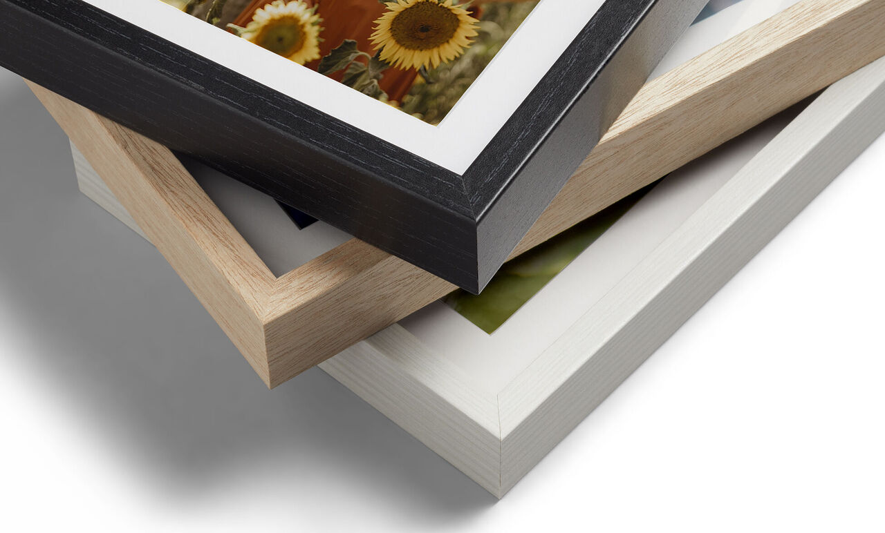 Three wooden frames stacked on top of each other in different colors