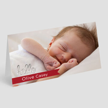 A cute baby shows its arm with a cheerful greeting.