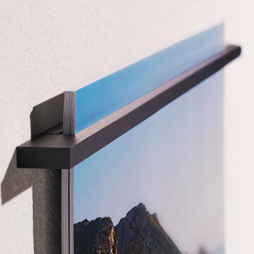 A hung wall picture with a beautiful landscape, showcased on the wall