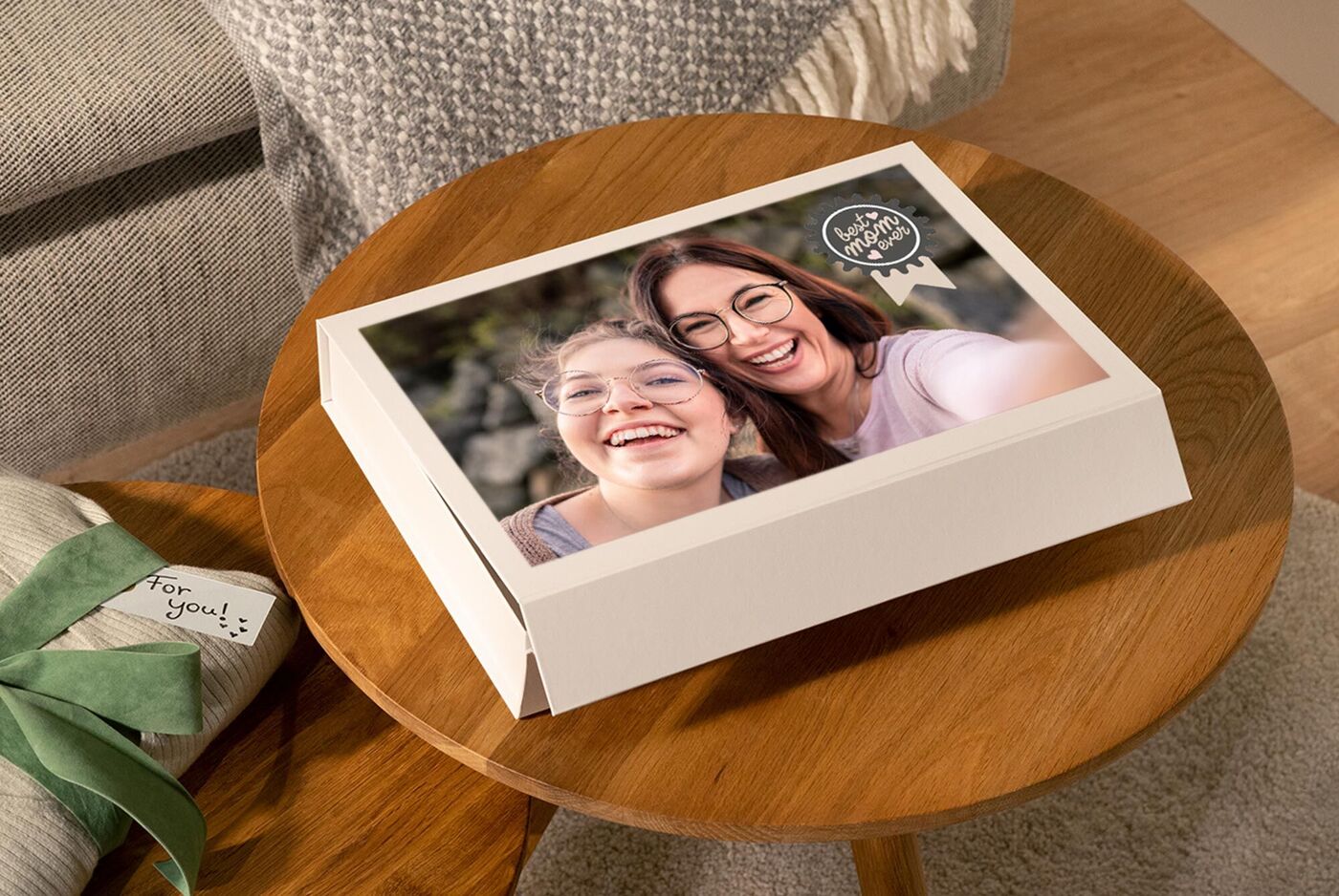 A beautifully designed photo book lies on a table. It features a cheerful couple in the foreground.