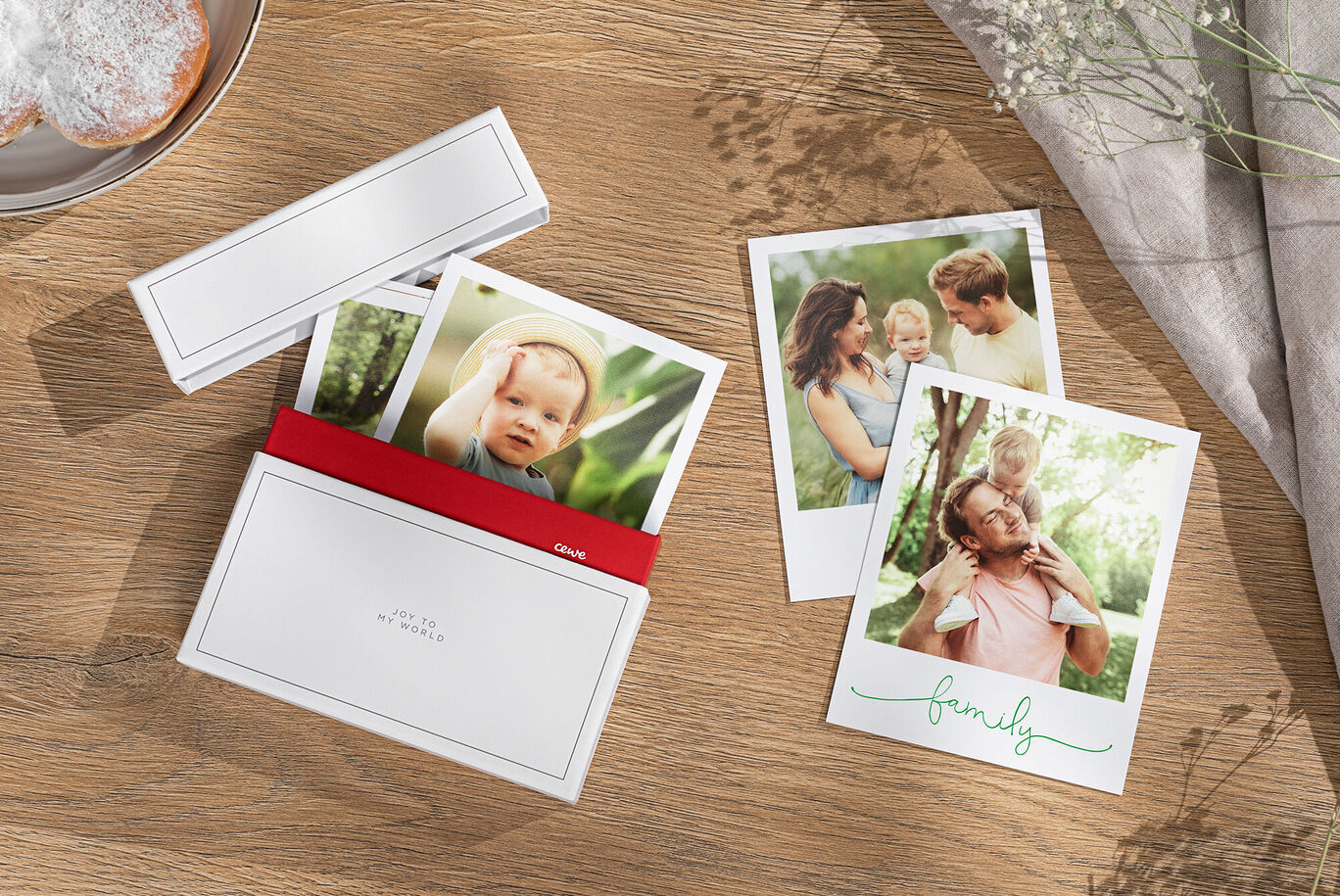 Two photos of a happy family enjoying moments outdoors, along with a red CEWE greeting card cover.
