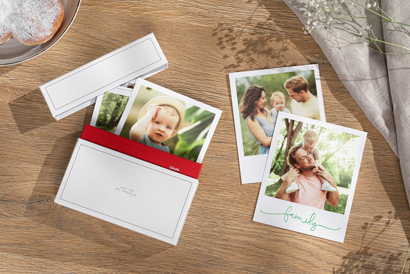 Two photos of a happy family enjoying moments outdoors, along with a red CEWE greeting card cover.