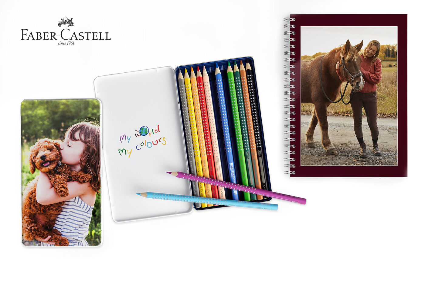A set of colored pencils and a notebook, next to a photo of a girl and a dog.