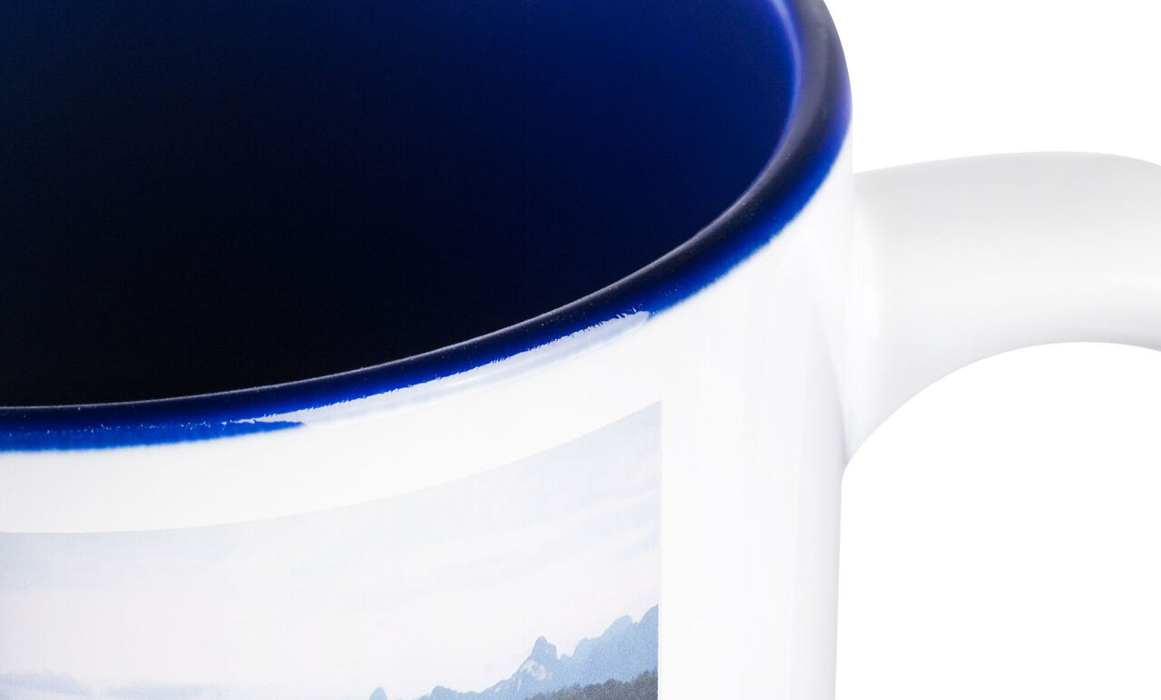 Mug with blue rim and photo of a mountain panorama