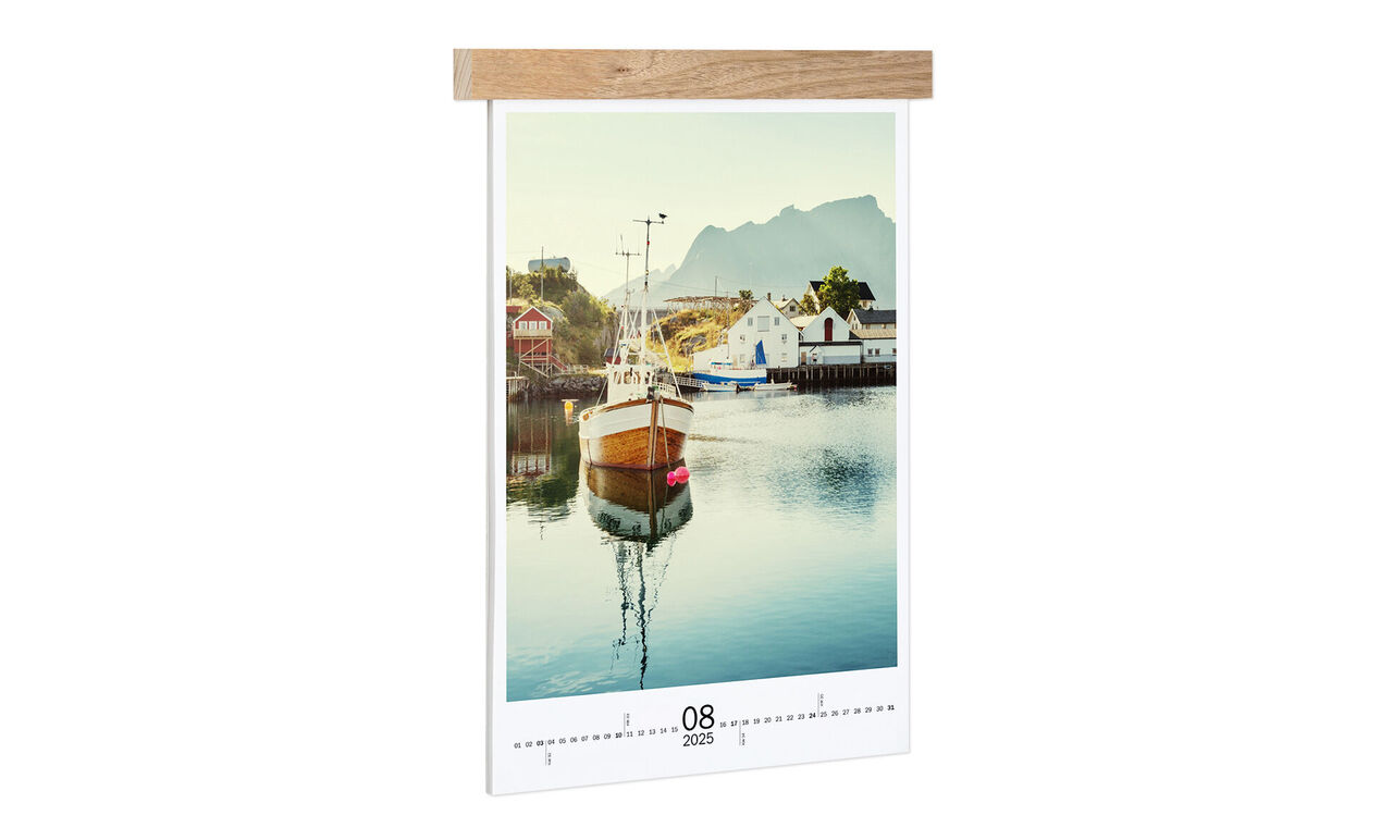A beautiful calendar with a boat on water and mountains in the background.