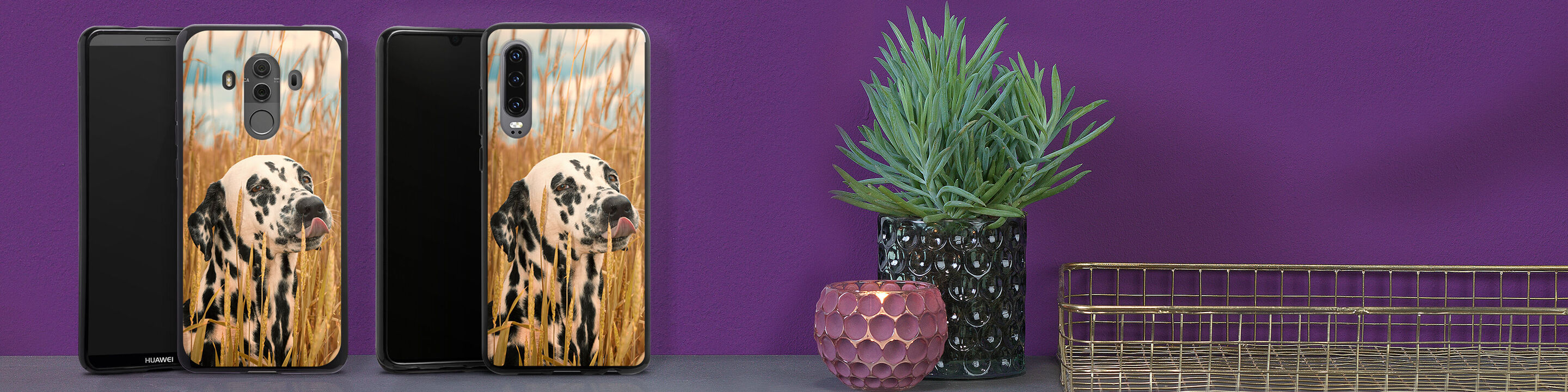 Two phone cases with a Dalmatian image are on a table.