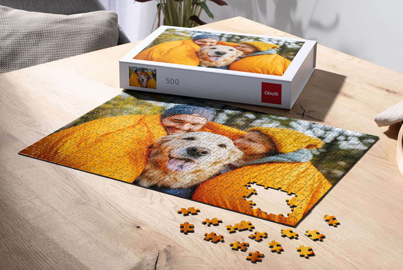 Family with dog happily puzzles at a table.