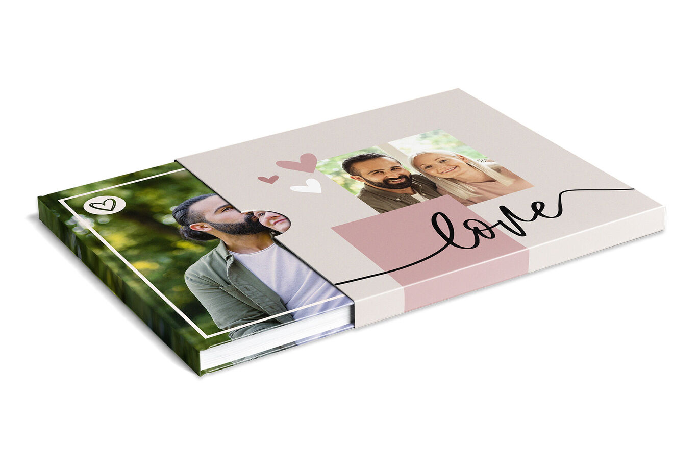 A lovingly designed CEWE PHOTO BOOK lies on a table. It features a typical cover with hearts and a personal photo of the couple.