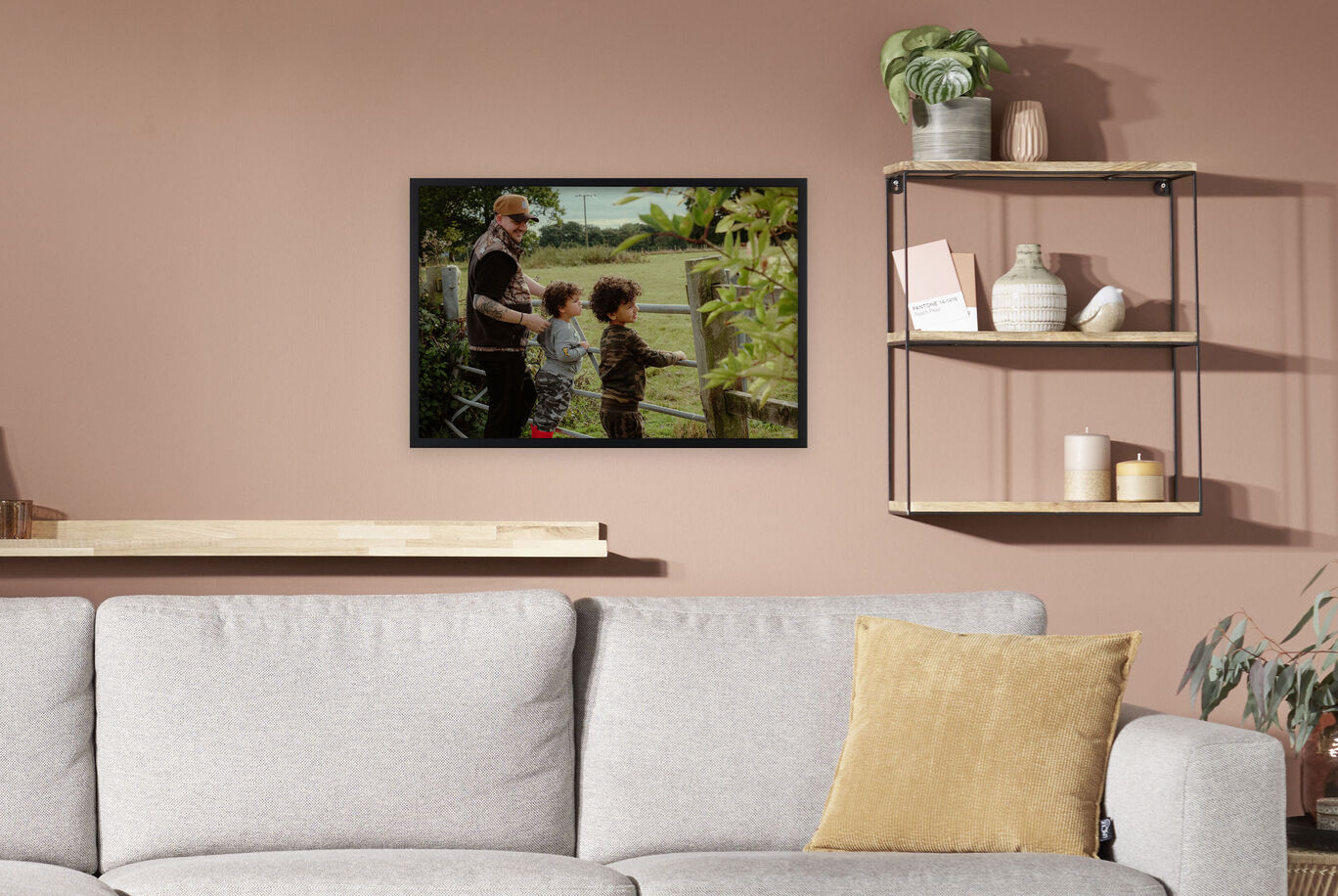 Two kids and an adult observe nature through a window in the living room.