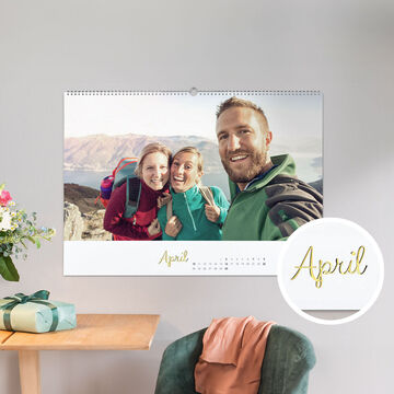 A cheerful family calendar displays the month of April with hiking pictures in the countryside.