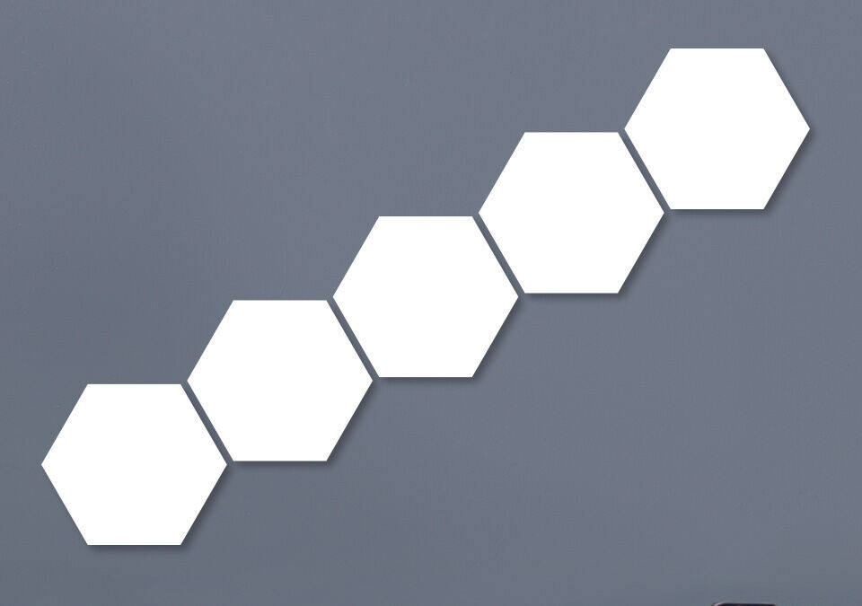 Five connected empty hexagon shapes on a gray wall.